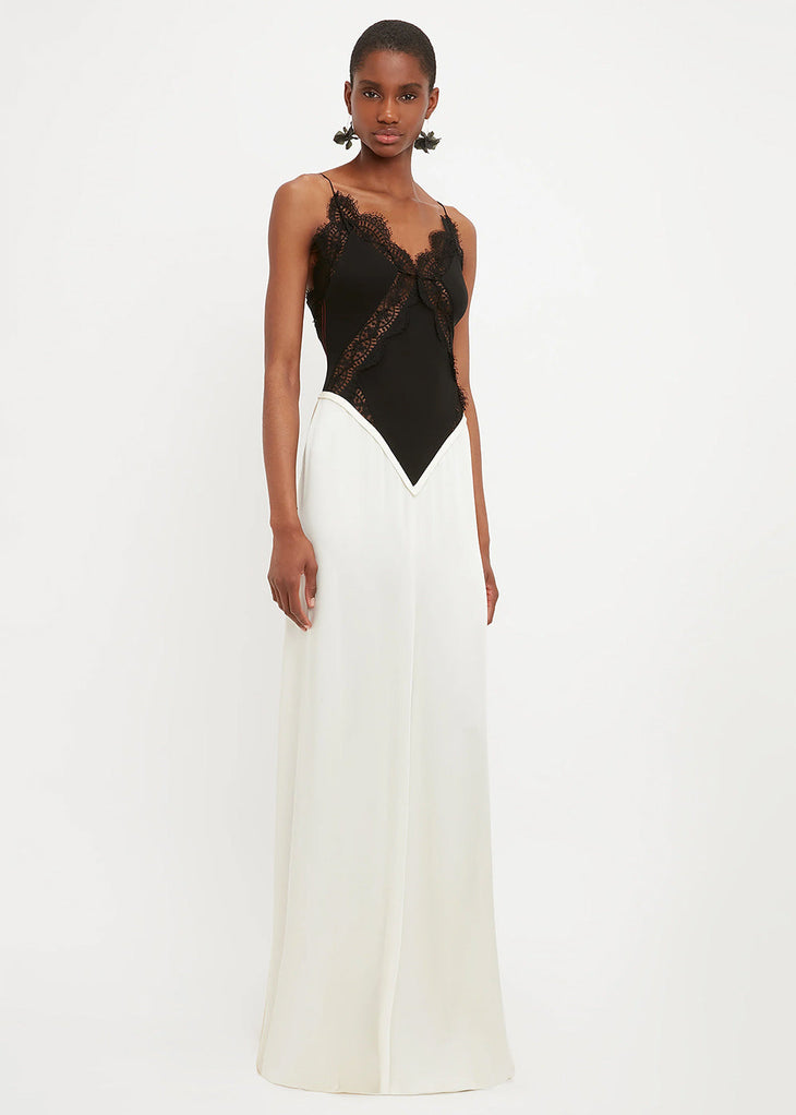 Woman wearing black lace insert bodysuit with cream floor-length skirt — Victoria Beckham | Endless UAE