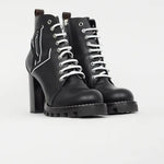 Black leather lace-up ankle boots with chunky block heels and white star logo detail on ridged rubber sole — Louis Vuitton | Endless UAE