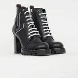 Black leather lace-up ankle boots with chunky block heels and white star logo detail on ridged rubber sole — Louis Vuitton | Endless UAE