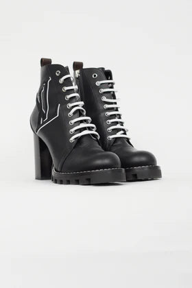 Black leather lace-up ankle boots with chunky block heels and white star logo detail on ridged rubber sole — Louis Vuitton | Endless UAE
