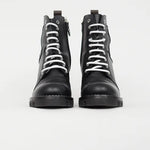 Black leather combat boots with white laces and logo detail, front view — Louis Vuitton | Endless UAE