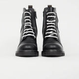 Black leather combat boots with white laces and logo detail, front view — Louis Vuitton | Endless UAE