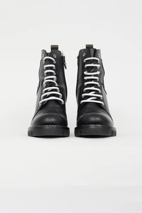 Black leather combat boots with white laces and logo detail, front view — Louis Vuitton | Endless UAE