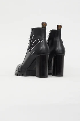 Black leather ankle boots with chunky heels, logo star detail, and pull tabs viewed from behind — Louis Vuitton | Endless UAE