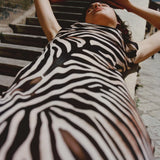 Woman wearing black and cream zebra stripe maxi dress with cowl neckline — Endless | Endless UAE