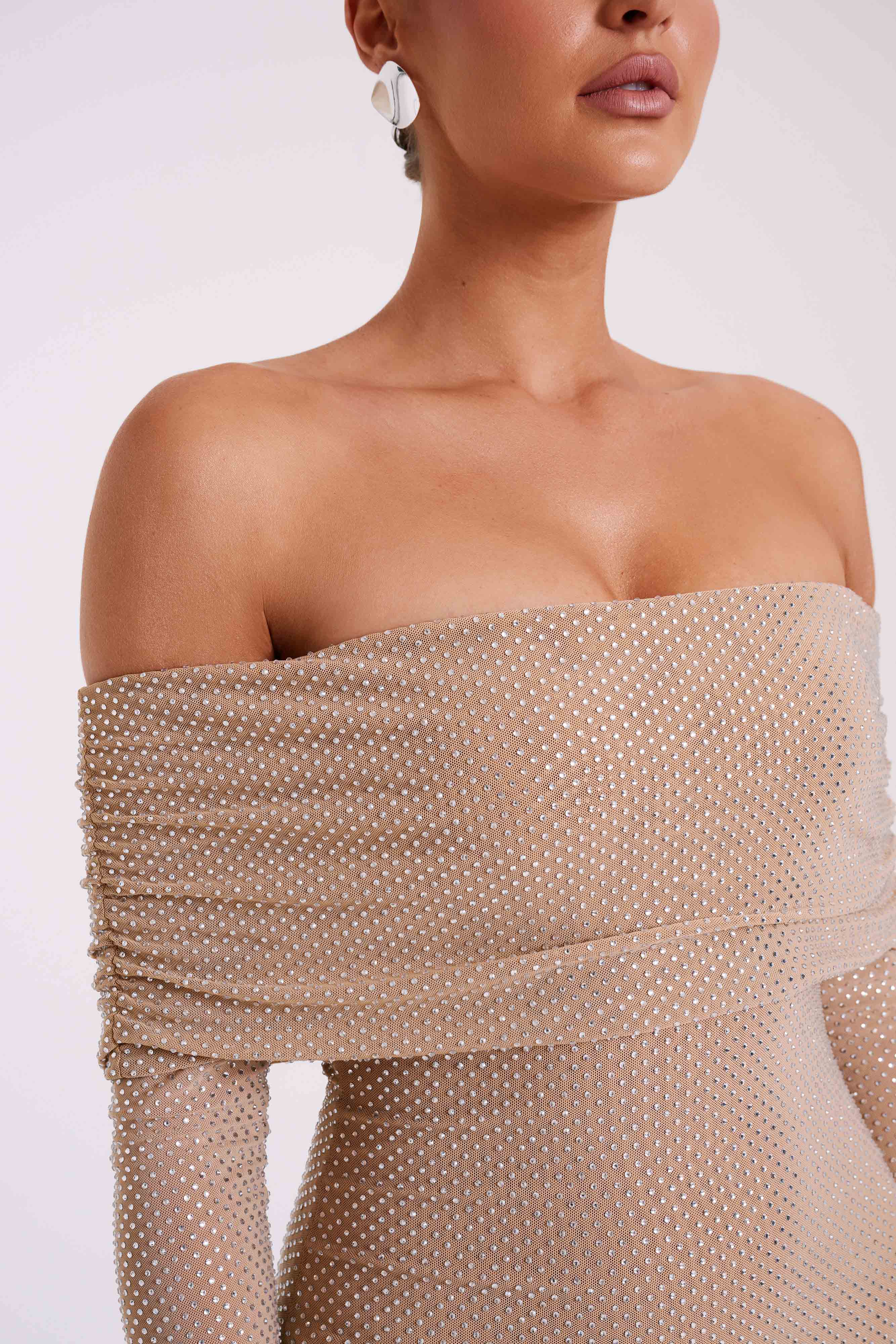 Woman wearing beige off-shoulder diamante maxi dress with long sleeves — Meshki | Endless UAE