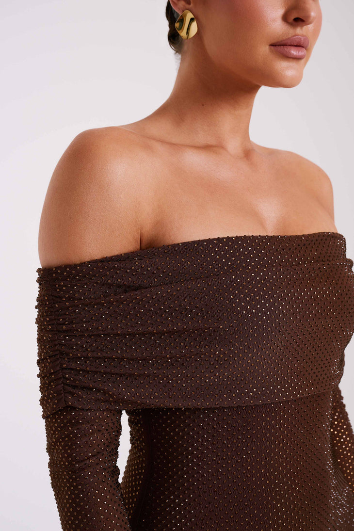 Woman wearing chocolate brown off-shoulder diamante embellished maxi dress with long sleeves and gold earrings — Meshki | Endless UAE