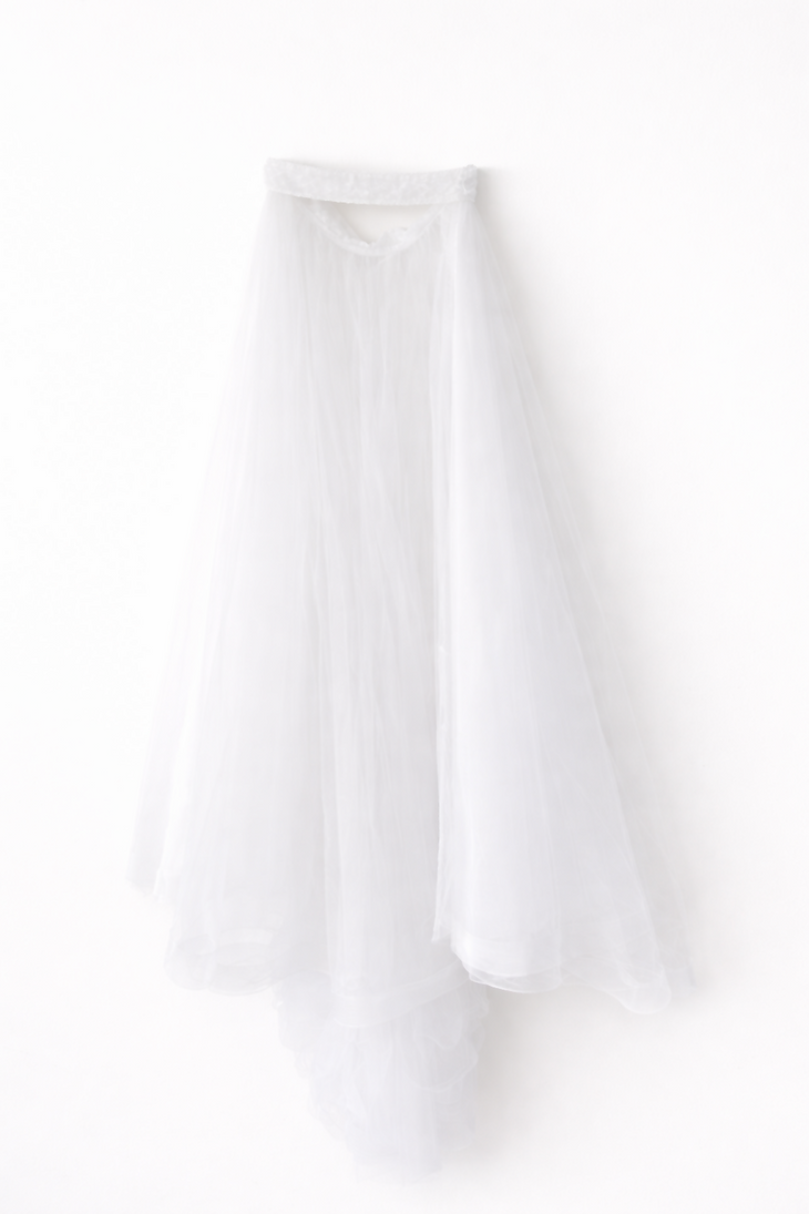 Elegant white lace wedding dress with long sleeves and flowing tulle train — Tatiana Kaplun | Endless UAE
