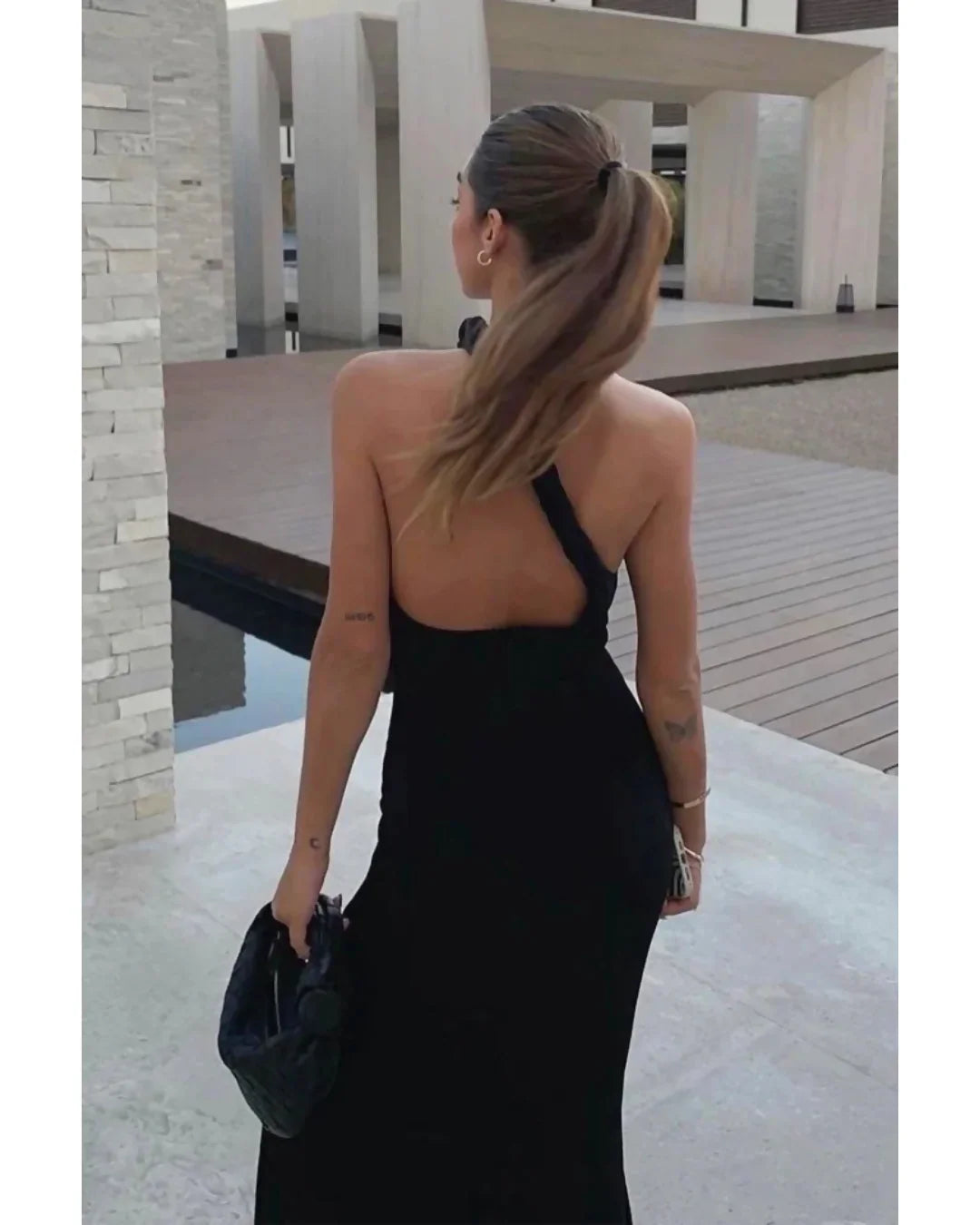 Black one-shoulder velvet midi dress with red quilted bag and gold heeled sandals — Misha | Endless UAE