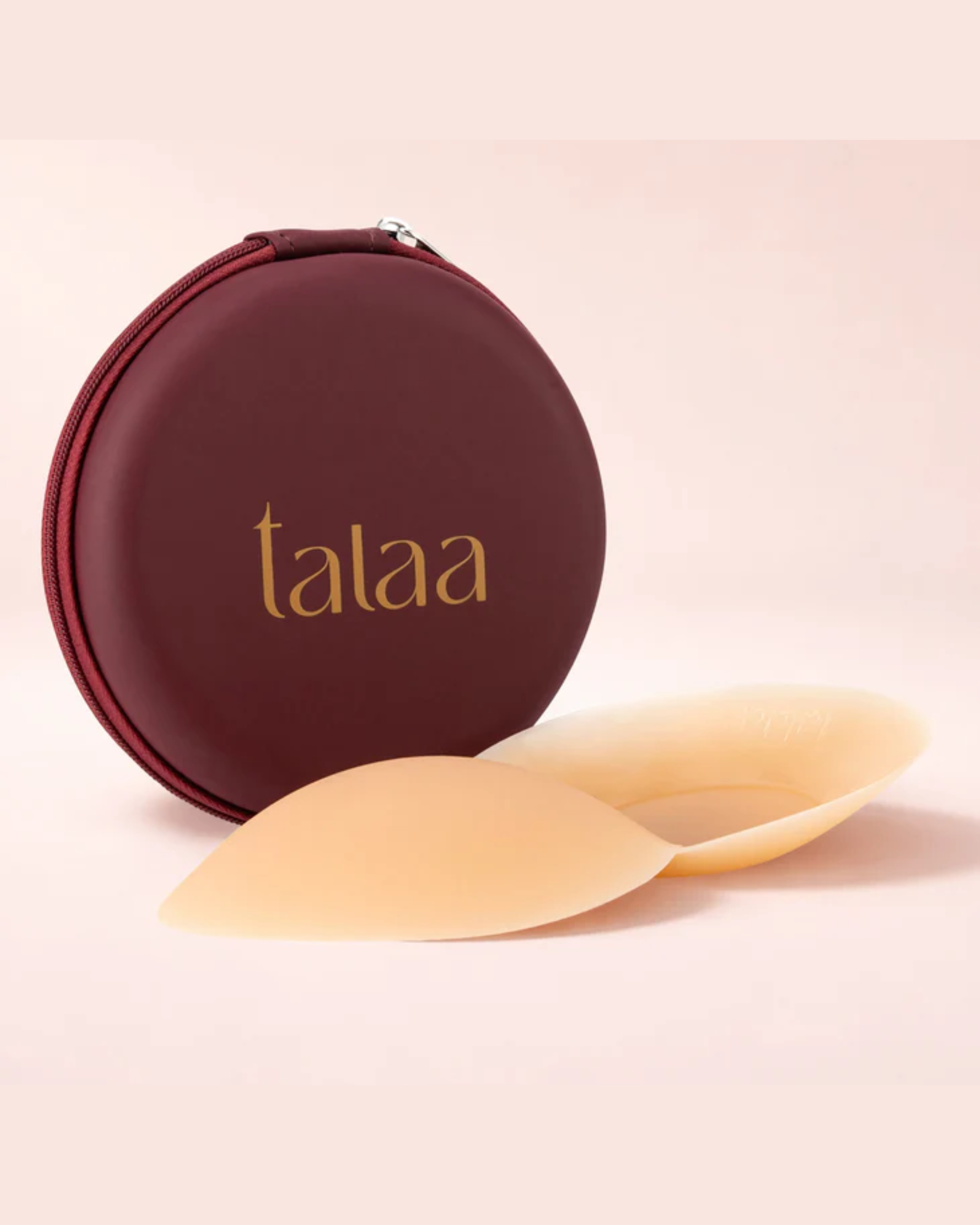 Beige silicone nipple covers with burgundy round storage case on white background — Talaa | Endless UAE
