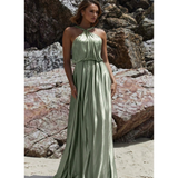 Bloom sage green halter neck flowing maxi dress on beach with rocky backdrop — You&I Bridal | Endless UAE