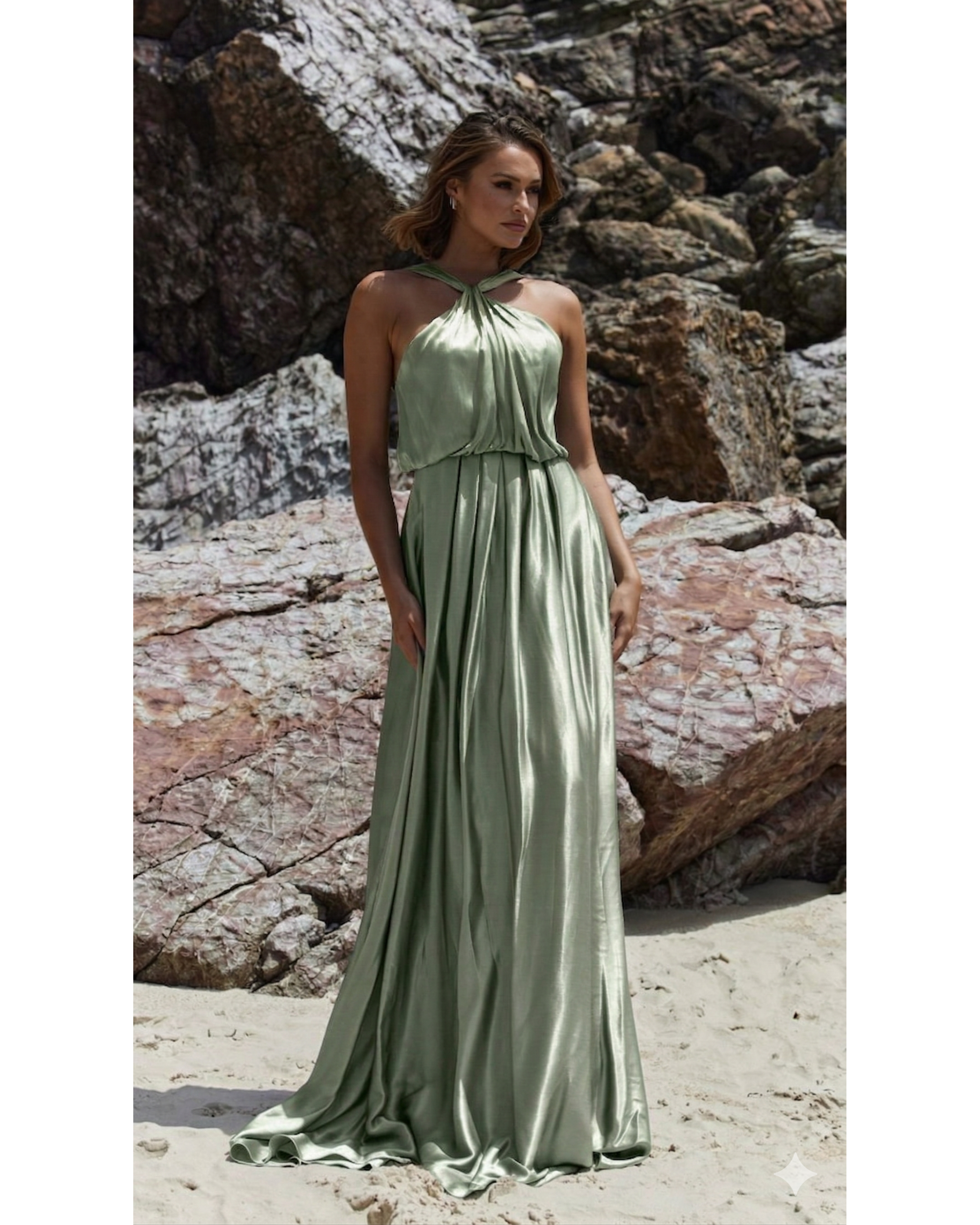 Bloom sage green halter neck flowing maxi dress on beach with rocky backdrop — You&I Bridal | Endless UAE