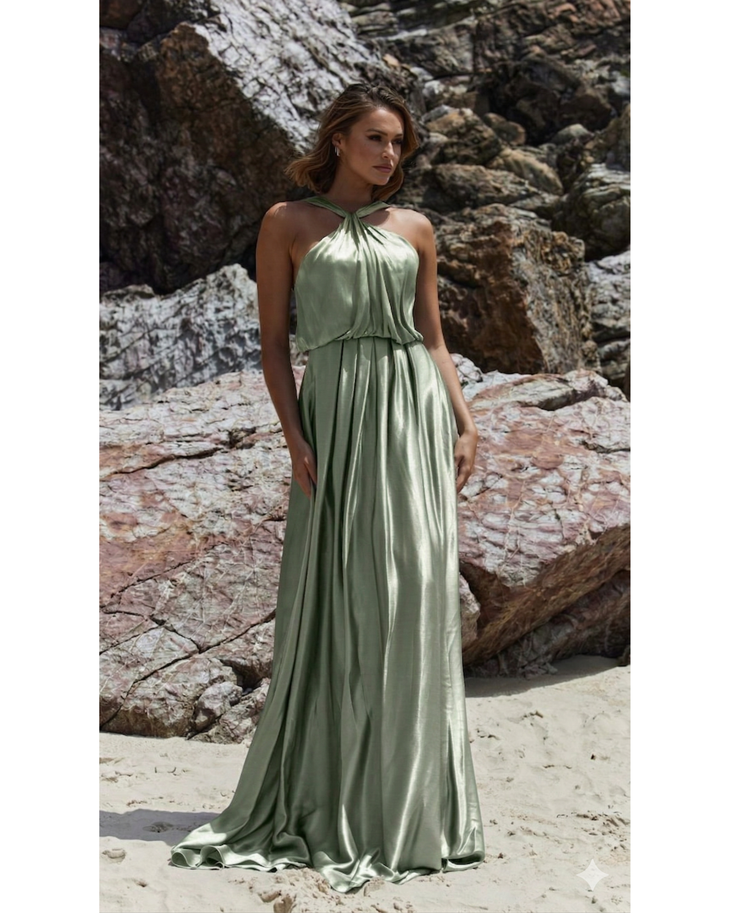Bloom sage green halter neck flowing maxi dress on beach with rocky backdrop — You&I Bridal | Endless UAE