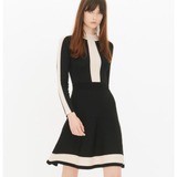 Black knit dress with cream contrast trim panel, long sleeves, and flared skirt silhouette — Sandro | Endless UAE
