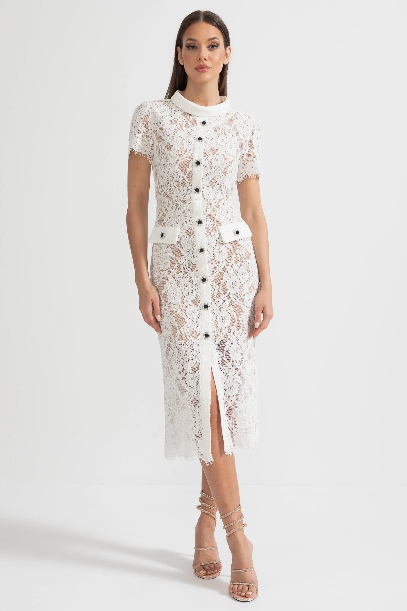 Elegant white lace midi dress with button details, short sleeves, front slit, and belt detail worn with strappy heels — self portrait | Endless UAE