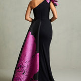 Black mermaid gown with magenta floral train and ruffled shoulder detail — In Couture | Endless UAE