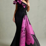 Black mermaid gown with magenta floral train and ruffled shoulder detail — In Couture | Endless UAE