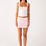 Woman wearing white halter top and pink sequin mini skirt — Peppermayo | Endless UAE
