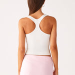 Woman wearing white halter top and pink sequin mini skirt — Peppermayo | Endless UAE
