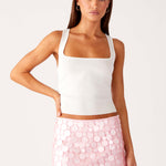 Woman wearing white halter top and pink sequin mini skirt — Peppermayo | Endless UAE