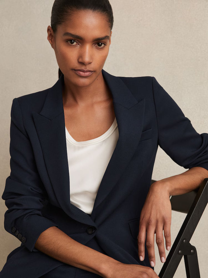 Woman wearing navy single-breasted tailored blazer with white top, professional business attire — Reiss | Endless UAE