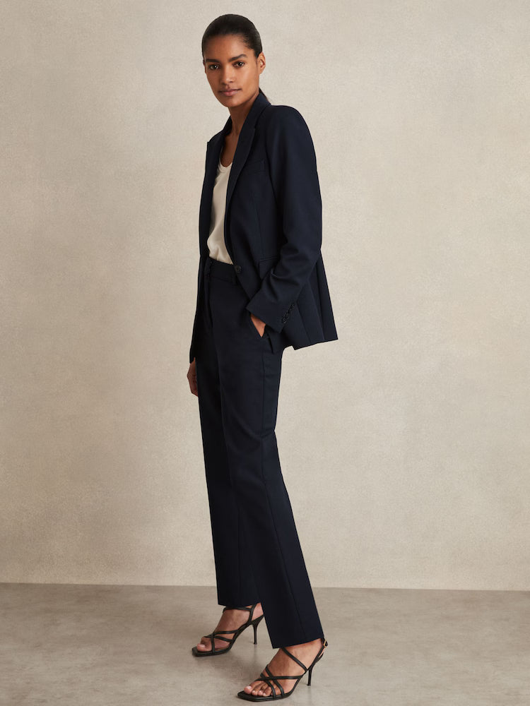 Professional woman wearing navy Gabi Petite tailored single-breasted blazer with matching trousers and strappy heels — Reiss | Endless UAE