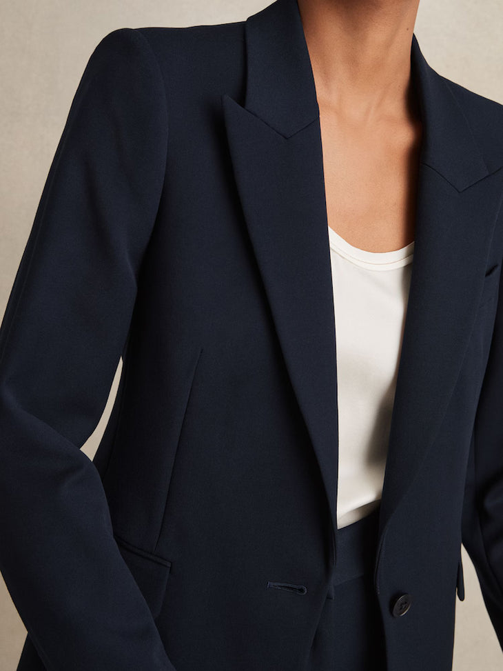 Navy tailored single breasted blazer with notch lapels and button closure, worn over white top — Reiss | Endless UAE