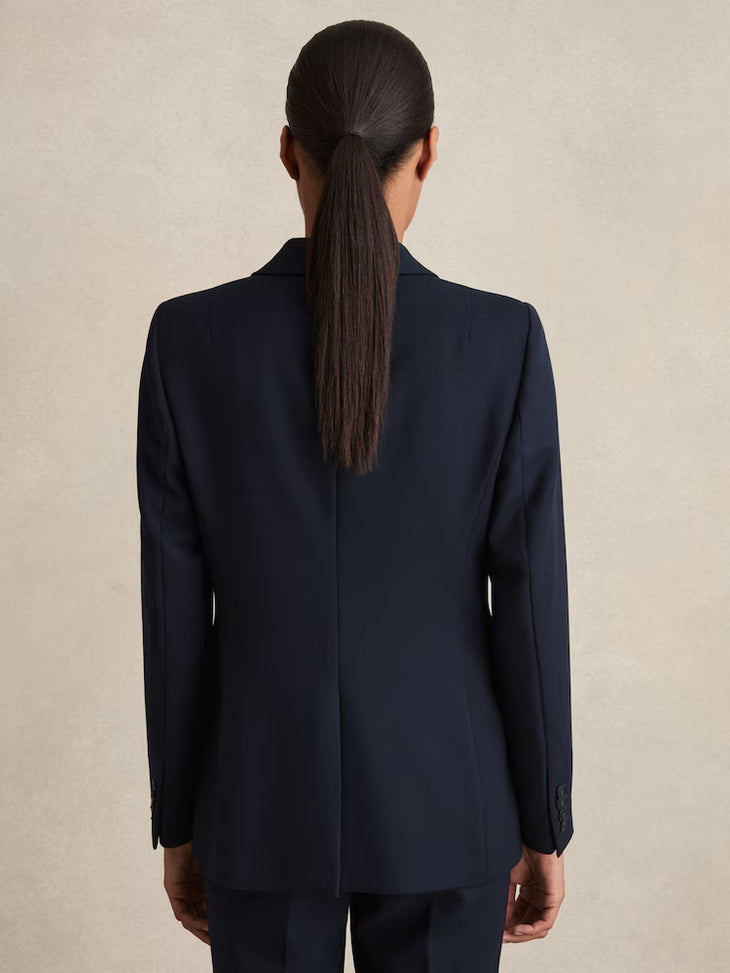 Back view of woman wearing navy blue tailored single-breasted blazer with sleek ponytail hairstyle — Reiss | Endless UAE