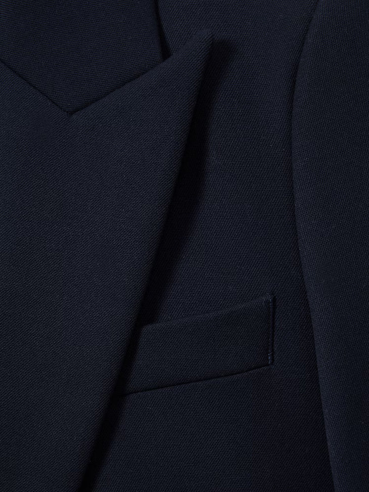 Close-up of navy blue textured tailored blazer showing lapel, chest and pocket detail — Reiss | Endless UAE