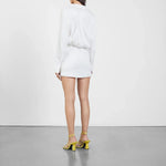White wrap mini dress with long sleeves and gold strappy sandals — Gauge81 | Endless UAE