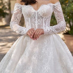 Elegant white lace off-shoulder ball gown wedding dress with long sleeves and sparkly tulle skirt — Sima Couture | Endless UAE