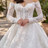 Elegant white lace off-shoulder ball gown wedding dress with long sleeves and sparkly tulle skirt — Sima Couture | Endless UAE
