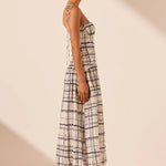 Woman wearing Niko Gathered Bubble Midi Dress in cream check pattern with strappy white sandals — Shona Joy | Endless UAE