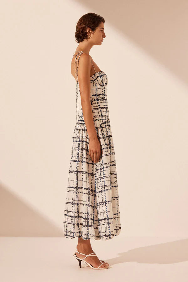 Woman wearing Niko Gathered Bubble Midi Dress in cream check pattern with strappy white sandals — Shona Joy | Endless UAE