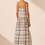Woman wearing Niko Gathered Bubble Midi Dress in cream check pattern with strappy white sandals — Shona Joy | Endless UAE