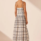 Woman wearing Niko Gathered Bubble Midi Dress in cream check pattern with strappy white sandals — Shona Joy | Endless UAE