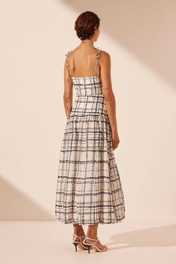 Woman wearing Niko Gathered Bubble Midi Dress in cream check pattern with strappy white sandals — Shona Joy | Endless UAE