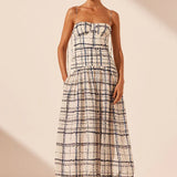 Woman wearing Niko Gathered Bubble Midi Dress in cream check pattern with strappy white sandals — Shona Joy | Endless UAE