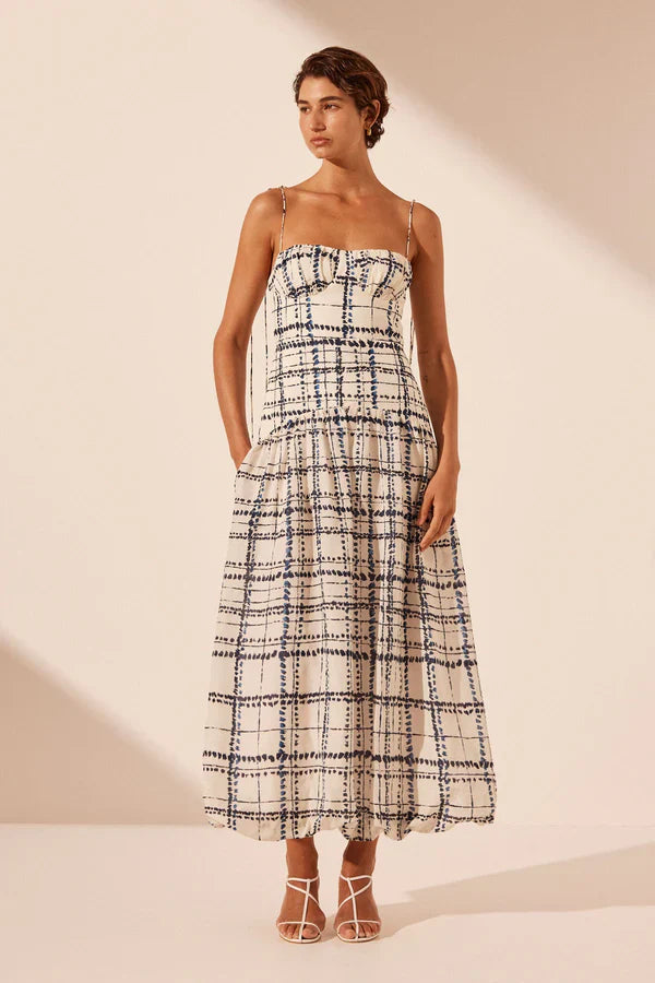 Woman wearing Niko Gathered Bubble Midi Dress in cream check pattern with strappy white sandals — Shona Joy | Endless UAE