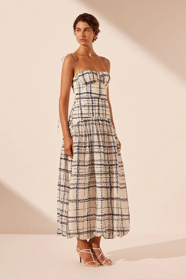 Woman wearing Niko Gathered Bubble Midi Dress in cream check pattern with strappy white sandals — Shona Joy | Endless UAE
