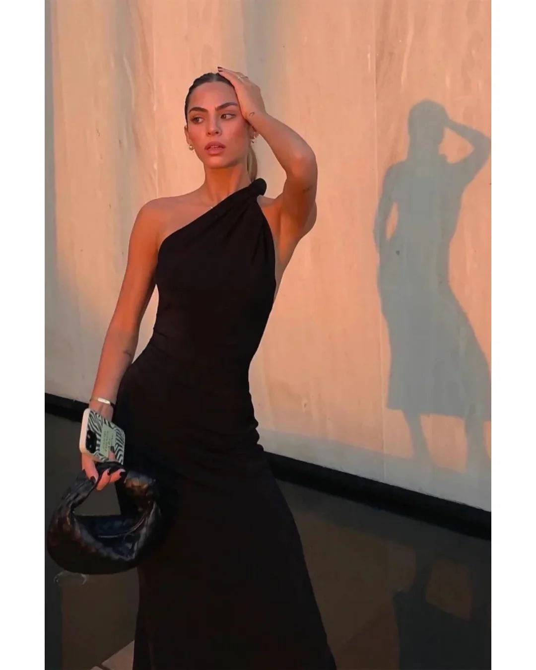 Black one-shoulder velvet midi dress with red quilted bag and gold heeled sandals — Misha | Endless UAE