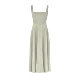 Woman wearing sage green square neck midi dress with pleated skirt and white slide sandals — Odd Muse | Endless UAE
