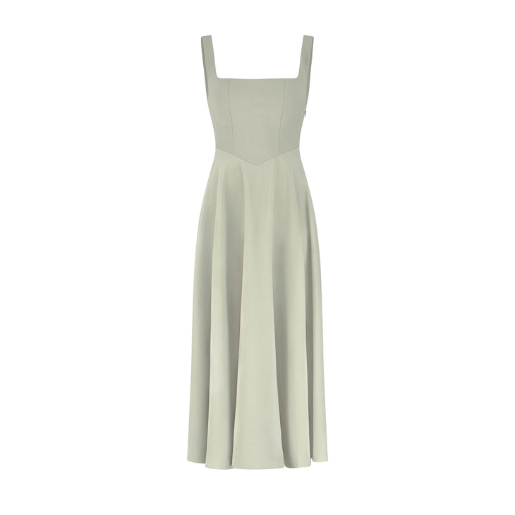 Woman wearing sage green square neck midi dress with pleated skirt and white slide sandals — Odd Muse | Endless UAE