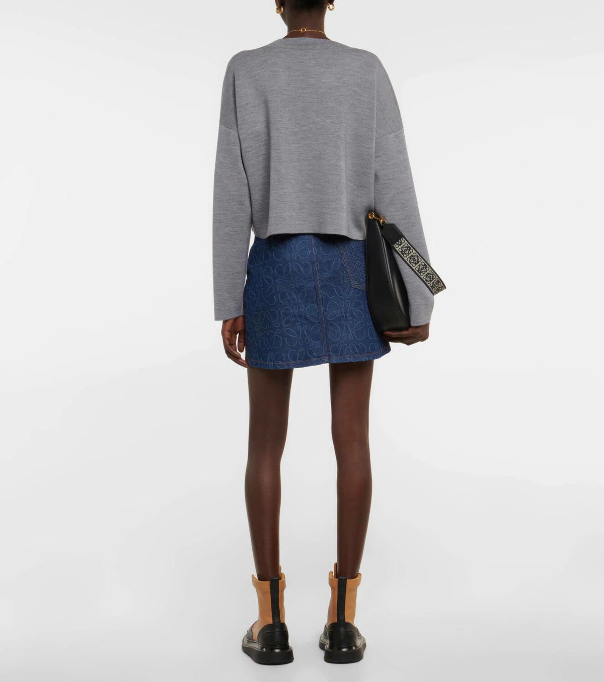 Gray wool-blend cropped sweater shown from back, styled with blue patterned mini skirt and black leather bag — Loewe | Endless UAE