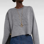 Gray wool-blend cropped sweater with embossed Anagram logo, styled with gold necklace and blue jeans — Loewe | Endless UAE