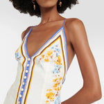 Woman wearing a floral printed white linen midi dress with blue and yellow trim — Zimmerman | Endless UAE