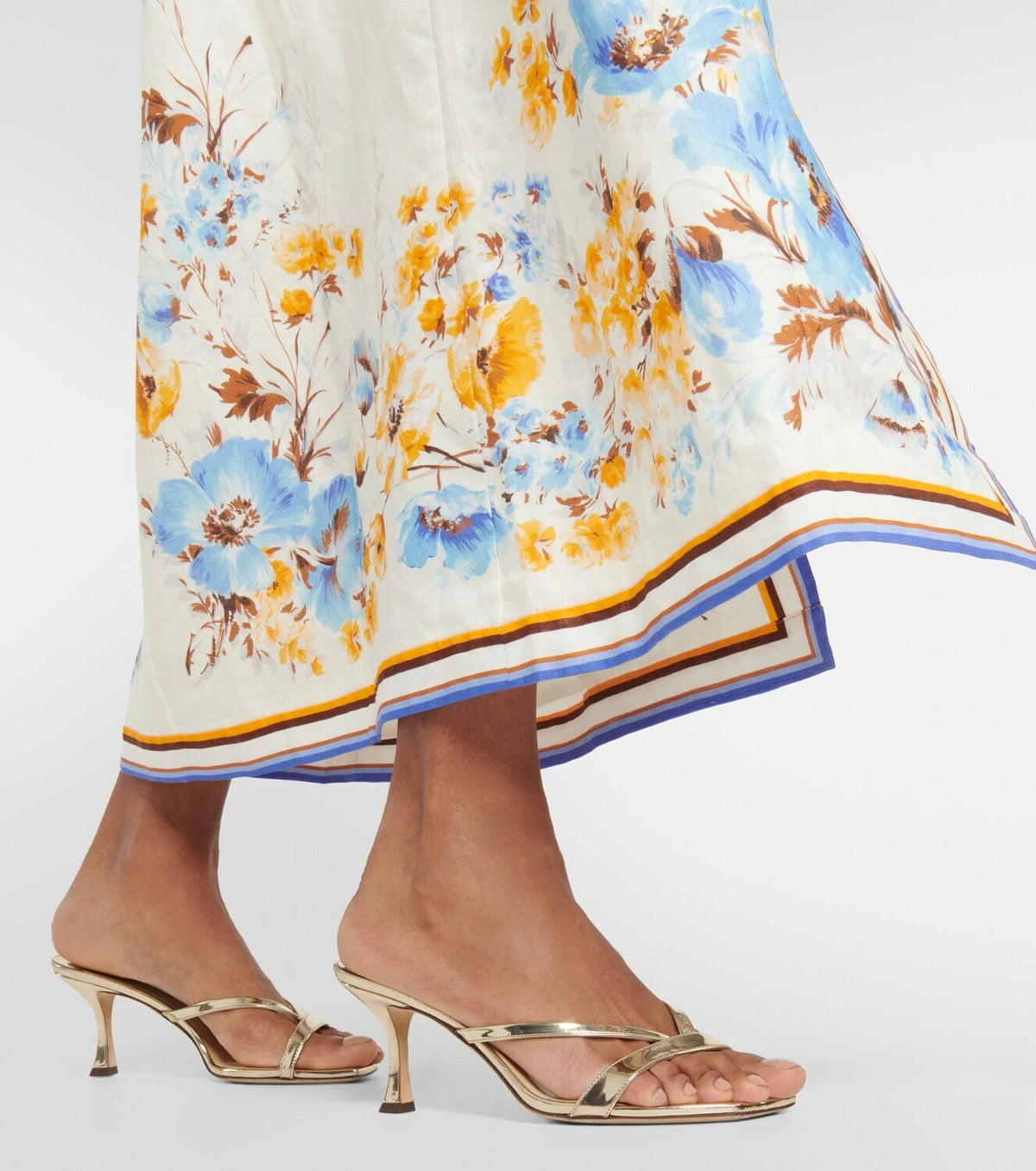 Woman wearing a floral printed white linen midi dress with blue and yellow trim — Zimmerman | Endless UAE