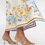 Woman wearing a floral printed white linen midi dress with blue and yellow trim — Zimmerman | Endless UAE