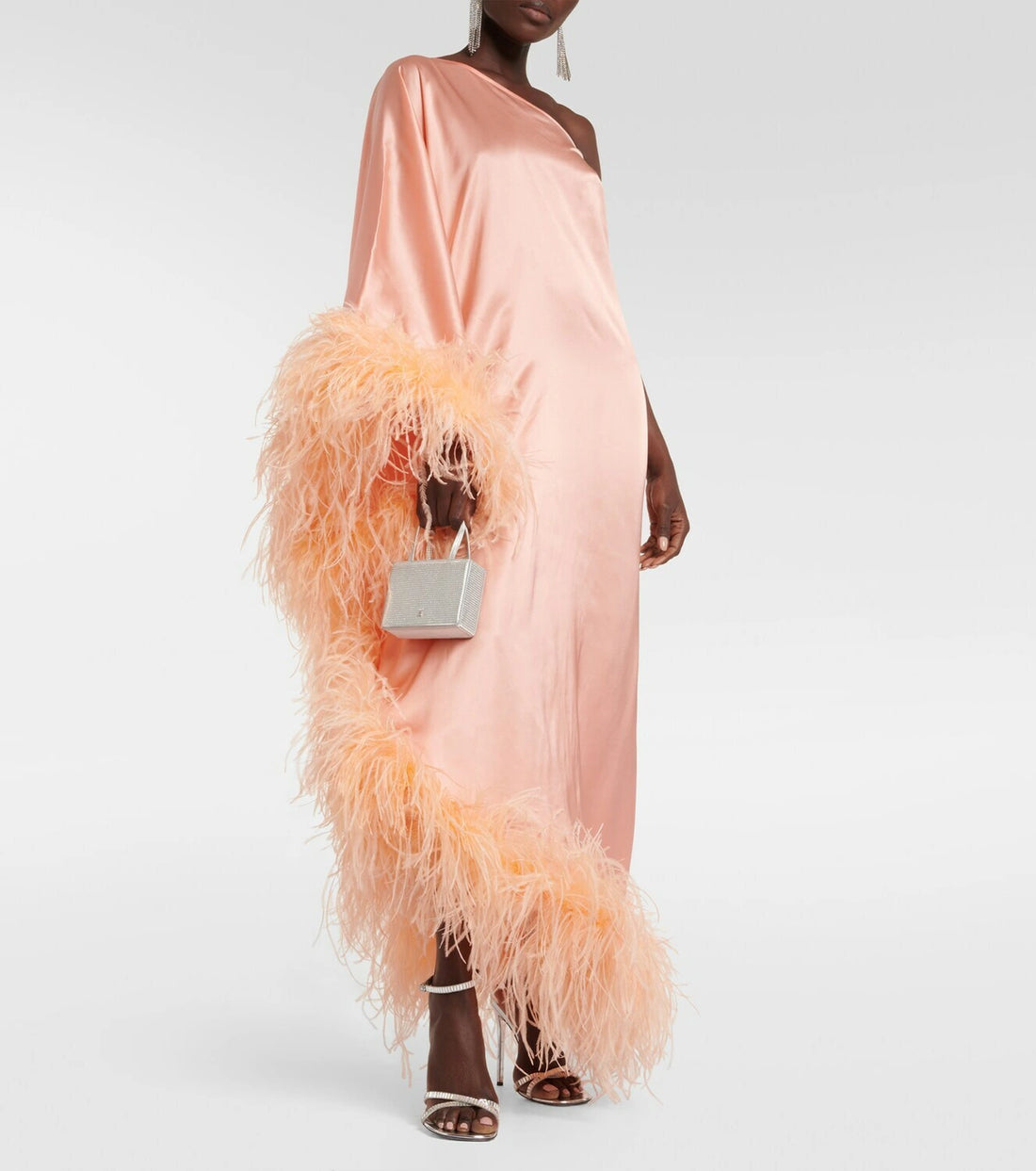 Peach silk one-shoulder maxi dress with feather trim and silver clutch — Taller Marmo | Endless UAE
