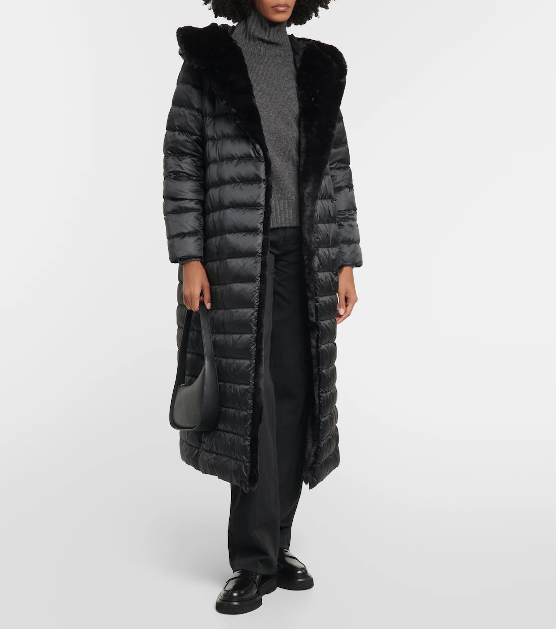 Black quilted down coat with faux fur hood collar worn with gray turtleneck sweater and black trousers — Max Mara | Endless UAE